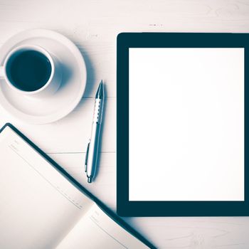 tablet with notebook and coffee cup over white table vintage style