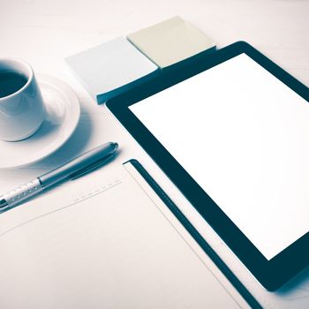 tablet with notebook and coffee cup over white table vintage style
