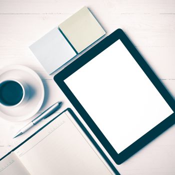 tablet with notebook and coffee cup over white table vintage style