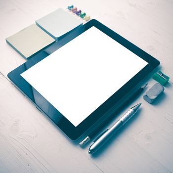 tablet with office supplies over white table vintage style