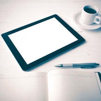 tablet with office supplies over white table vintage style