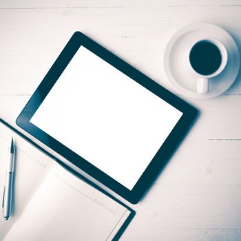 tablet with notebook and coffee cup over white table vintage style