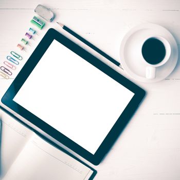 tablet with notebook and coffee cup over white table vintage style