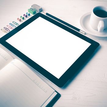 tablet with office supplies over white table vintage style