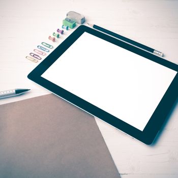 tablet with office supplies over white table vintage style