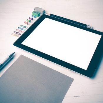 tablet with office supplies over white table vintage style