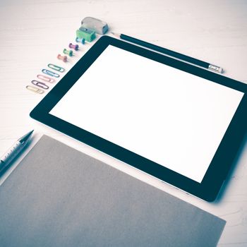 tablet with office supplies over white table vintage style