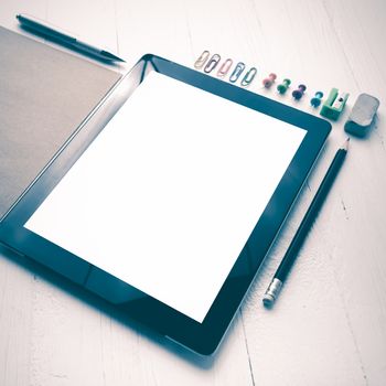 tablet with office supplies over white table vintage style