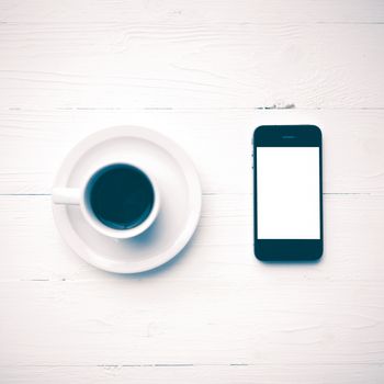 cellphone with coffee cup over white table vintage style
