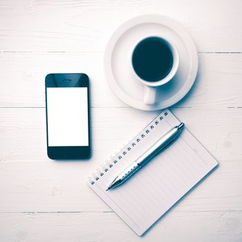 cellphone with notebook and coffee cup over white table vintage style