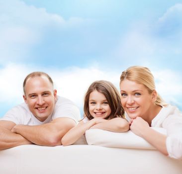 family, childhood and people - smiling mother, father and little girl over blue sky background