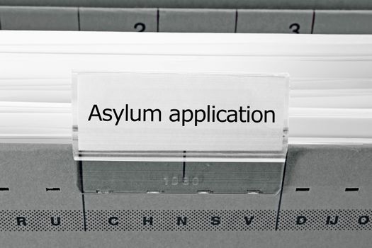 grey hanging file folder labeled with asylum application