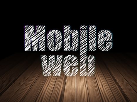 Web design concept: Glowing text Mobile Web in grunge dark room with Wooden Floor, black background