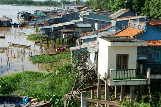 HONG NGU- VIET NAM- OCT 15: Residential on water, group of floating house of poor people on Mekong Delta river, precarious life, danger, home from sheet metal, Hongngu, Vietnam, Oct 15, 2015