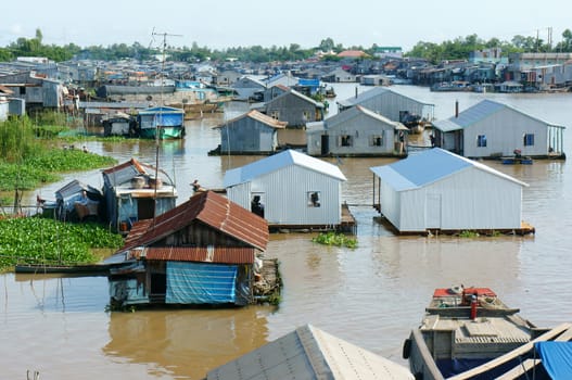 HONG NGU- VIET NAM- OCT 15: Residential on water, group of floating house of poor people on Mekong Delta river, precarious life, danger, home from sheet metal, Hongngu, Vietnam, Oct 15, 2015