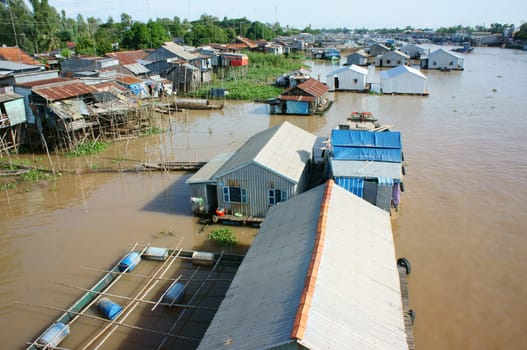 HONG NGU- VIET NAM- OCT 15: Residential on water, group of floating house of poor people on Mekong Delta river, precarious life, danger, home from sheet metal, Hongngu, Vietnam, Oct 15, 2015