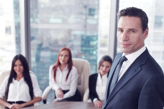 Group portrait of a professional business man and team looking confidently at camera