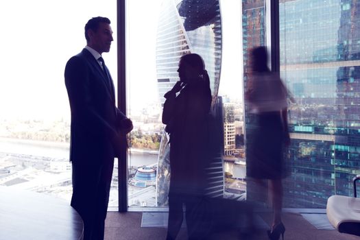 Business people talking in a conference room with city skyline