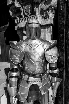 Medieval armor in front of the entrance to a castle.