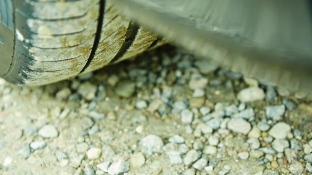 detail of a car wheel and some mud tainting the car