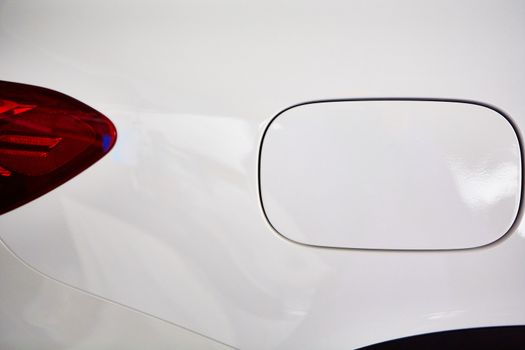 Detail on the rear light of a white car