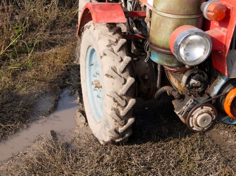 Small tractor with the manager stopped by the lake.