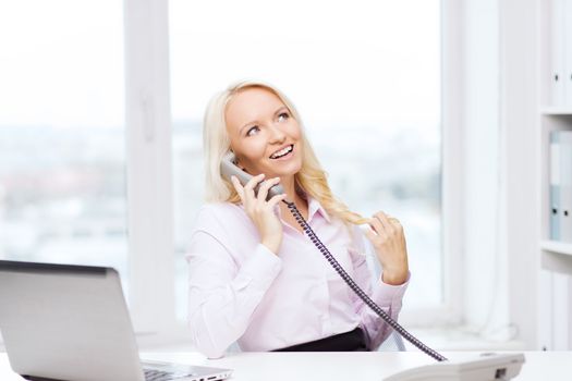 education, business, communication and technology concept - smiling businesswoman or student with laptop computer calling on phone in office