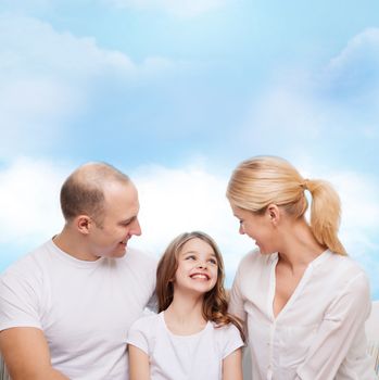 family, childhood and people - smiling mother, father and little girl over blue sky background