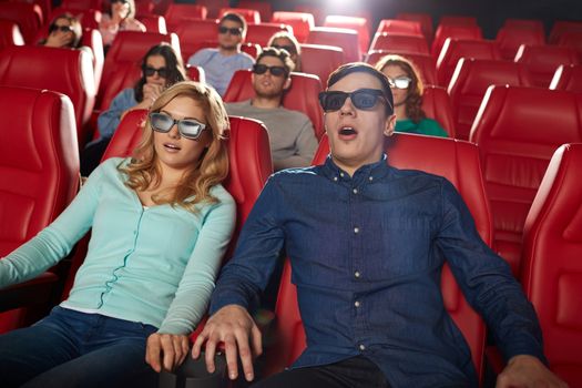 cinema, technology, entertainment and people concept - friends with 3d glasses watching horror or thriller movie in theater