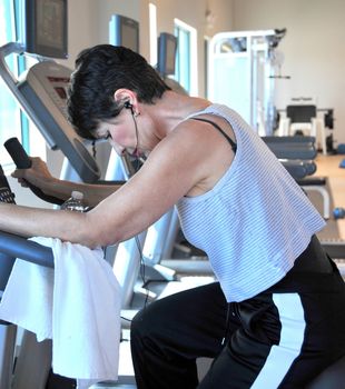 Mature female beauty working out inside a healthclub.