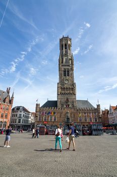 Bruges, Belgium - May 11, 2015: Tourist on Grote Markt square in Bruges, Belgium on May 11, 2015. The historic city centre is a prominent World Heritage Site of UNESCO.