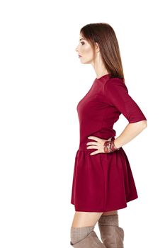 Side view of young woman posing in a red dress.