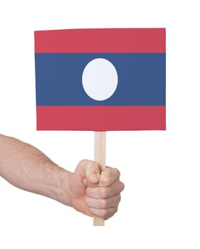 Hand holding small card, isolated on white - Flag of Laos