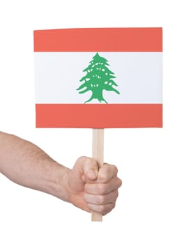 Hand holding small card, isolated on white - Flag of Lebanon