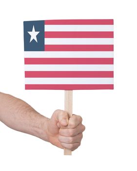 Hand holding small card, isolated on white - Flag of Liberia