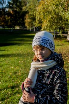 Young woman wearing glasses smiling in the fall