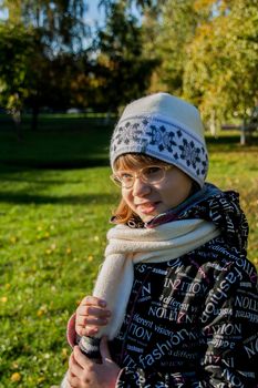 Young woman wearing glasses smiling in the fall