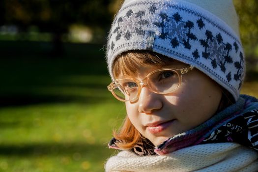 Young woman wearing glasses smiling in the fall