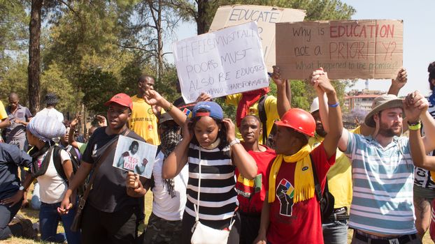 SOUTH AFRICA, Pretoria: Demonstrators run from police as an estimated 10,000 people gather at the Union Buildings on October 23, 2015.  The protesters demand that proposed tuition fee rises be scrapped, and called for the president, Jacob Zuma, to personally address their concerns.  It was the largest student protest since the 1976 Soweto uprising, a significant moment in the fight against South Africa's apartheid regime. 