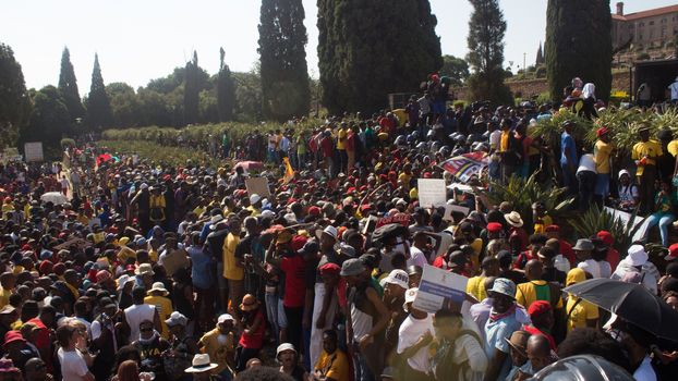 SOUTH AFRICA, Pretoria: Demonstrators run from police as an estimated 10,000 people gather at the Union Buildings on October 23, 2015.  The protesters demand that proposed tuition fee rises be scrapped, and called for the president, Jacob Zuma, to personally address their concerns.  It was the largest student protest since the 1976 Soweto uprising, a significant moment in the fight against South Africa's apartheid regime. 