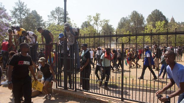SOUTH AFRICA, Pretoria: Demonstrators run from police as an estimated 10,000 people gather at the Union Buildings on October 23, 2015.  The protesters demand that proposed tuition fee rises be scrapped, and called for the president, Jacob Zuma, to personally address their concerns.  It was the largest student protest since the 1976 Soweto uprising, a significant moment in the fight against South Africa's apartheid regime. 