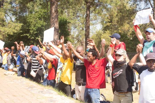 SOUTH AFRICA, Pretoria: Demonstrators run from police as an estimated 10,000 people gather at the Union Buildings on October 23, 2015.  The protesters demand that proposed tuition fee rises be scrapped, and called for the president, Jacob Zuma, to personally address their concerns.  It was the largest student protest since the 1976 Soweto uprising, a significant moment in the fight against South Africa's apartheid regime. 