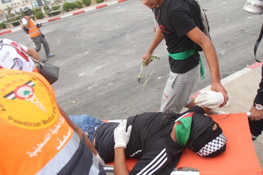 WEST BANK, Ramallah : A wounded Palestinian protester is evacuated by medics during clashes with Israeli security forces in the West Bank town of Ramallah, on the road towards Al-Bireh, near Beit El checkpoint, on October 23, 2015. Since October 1, at least 49 Palestinians and one Israeli Arab have been killed, including alleged attackers. Eight Israelis have been killed in attacks.