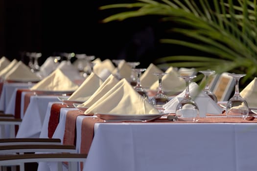 Glasses and plates on table in restaurant before the event