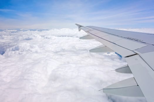 Frankfurt, Germany - May 30, 2013: Flight with an Airplane A319 from Airbus - window view with wing over the clouds.