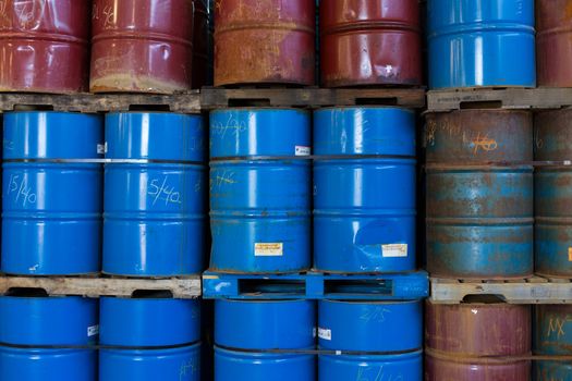 Rows of stacked steel barrels of various colors