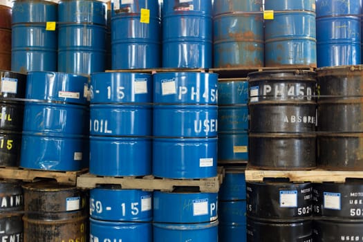 Rows of stacked steel barrels of various colors