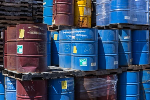 Rows of stacked steel barrels of various colors