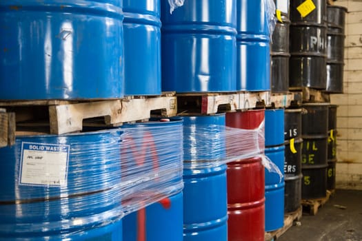 Rows of stacked steel barrels of various colors