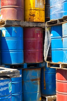 Rows of stacked steel barrels of various colors